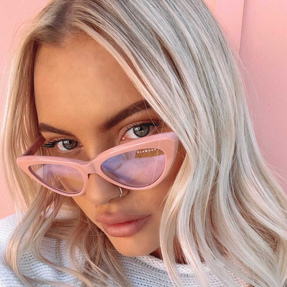 @chloenyrhinen wearing Milah by Glamour Glasses featuring a bold salmon pink cat eye frame - close up shot