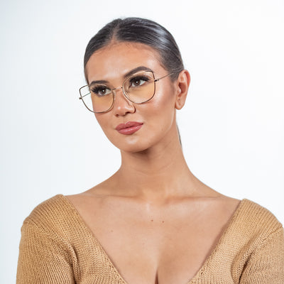 @gaellcameron wearing Foxy by Glamour Glasses featuring a oversized cat-eye frame in a delicate gold and brown - distant gaze