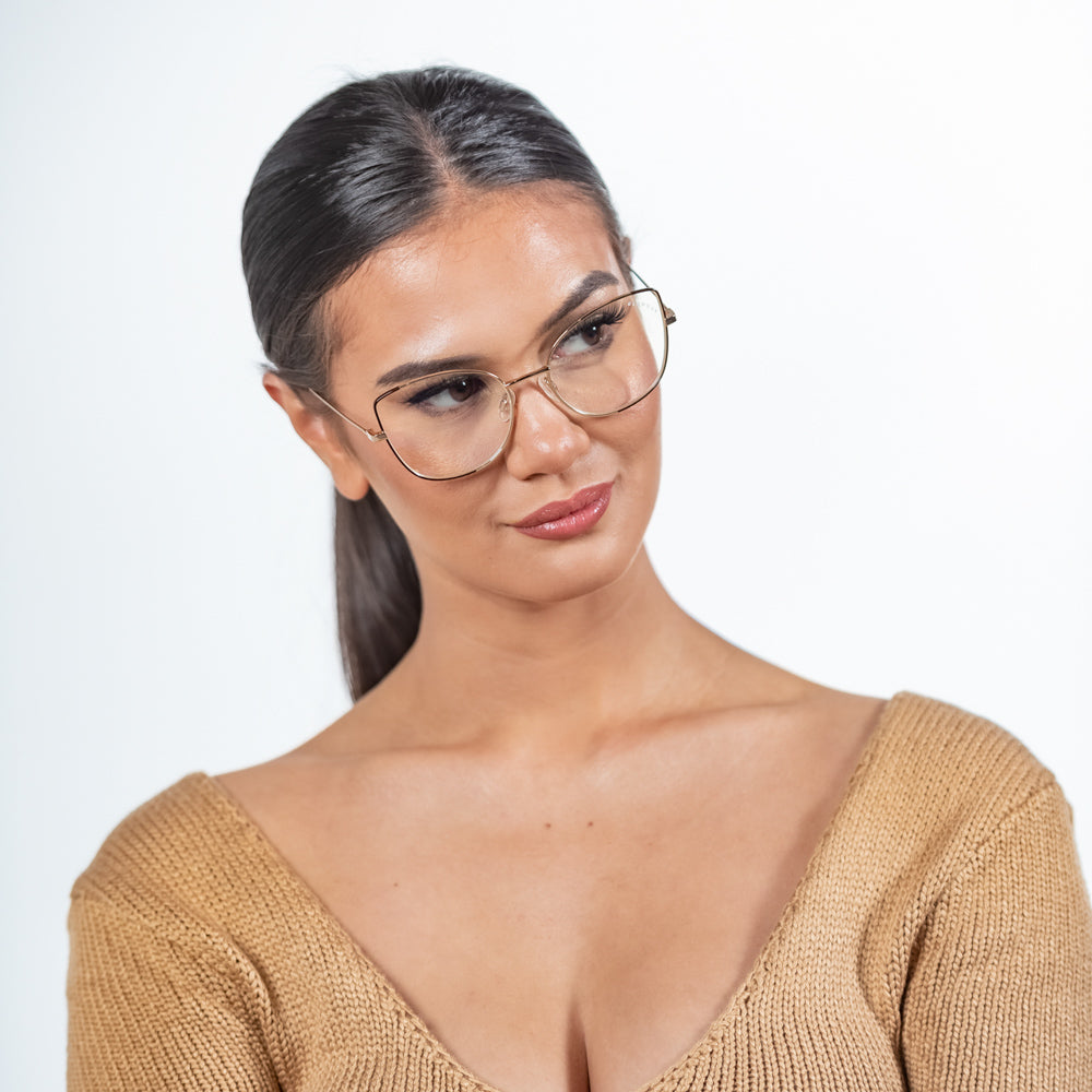 @gaellcameron wearing Foxy by Glamour Glasses featuring a oversized cat-eye frame in a delicate gold and brown - head tilted