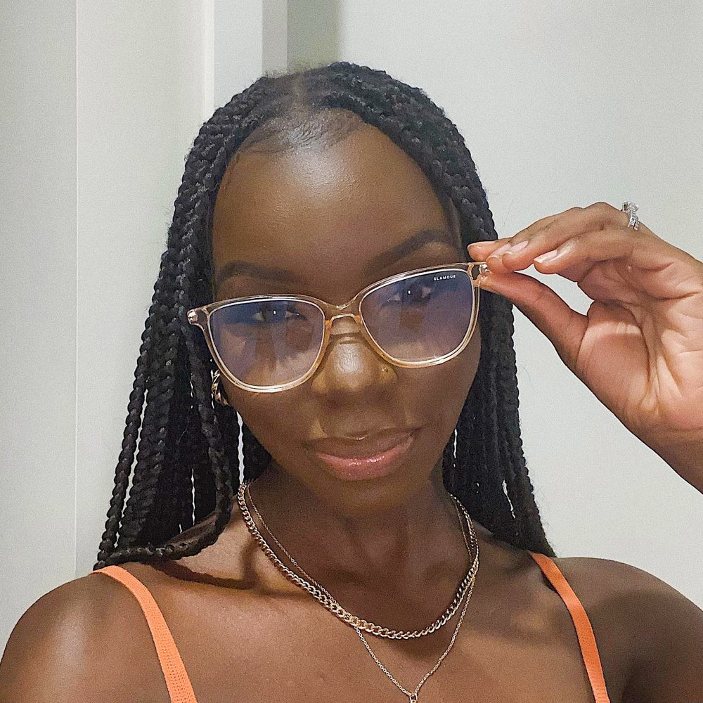 @kristineachayo wearing Pink Ice by Glamour Glasses featuring a transparent light pink acetate frame and golden temples