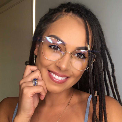 @tahliraftery wearing Lexi by Glamour Glasses featuring a thin golden cat eye frame - front shot